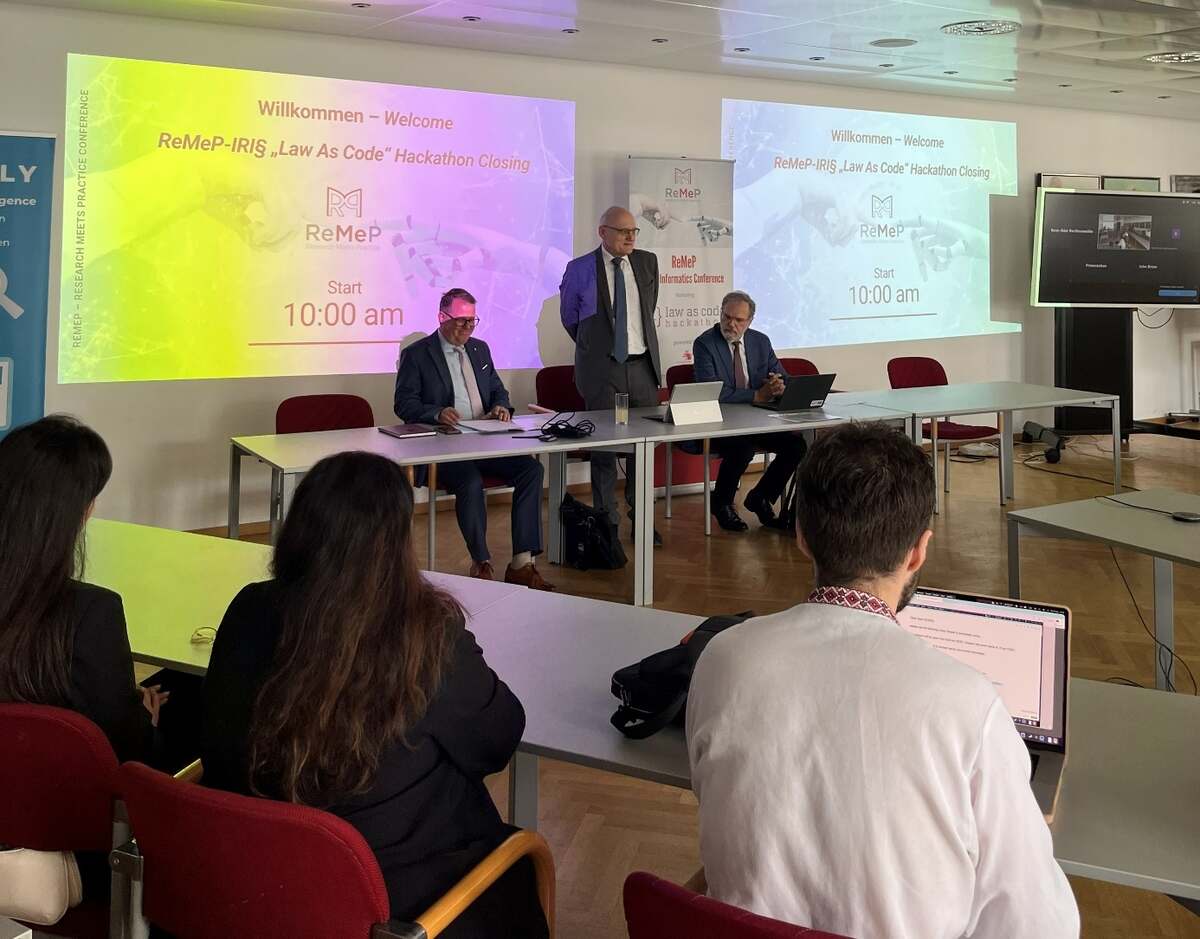 Opening of the final ceremony in front of the welcome slide “ReMeP-IRI§ Law As Code Hackathon Closing”